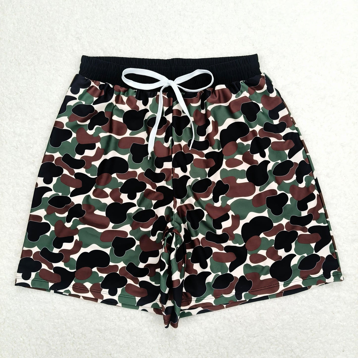 Beige swim trunks with brown and green camouflage