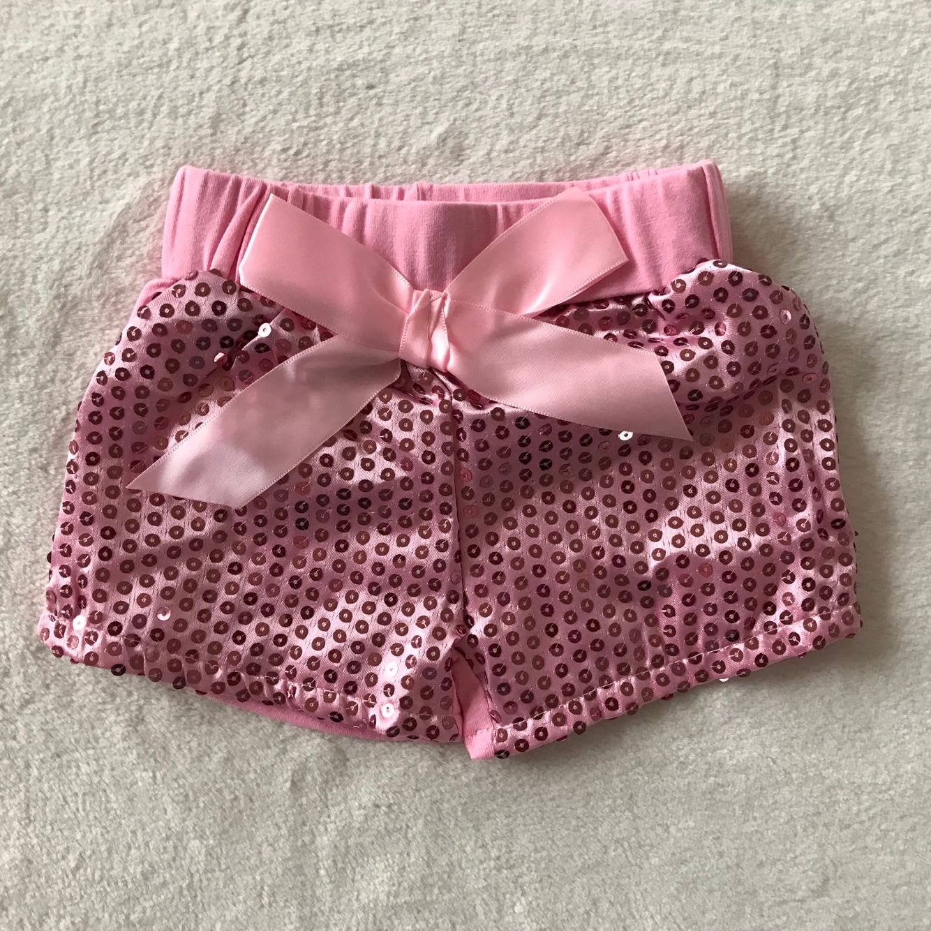 G2-6]. Pink bow sequin shorts