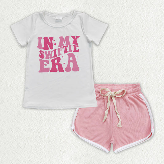 GT0437+SS0291 in my swiftie era white short sleeve top with letters PINK shorts